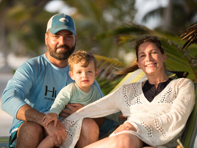 Family enjoying a sunny beach day at El Pescador